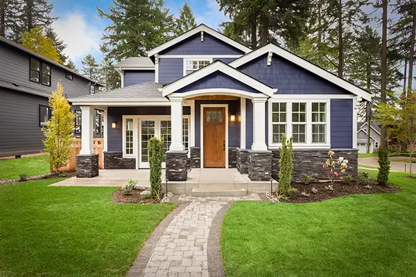 A quaint home with a beautiful concrete paver walkway.